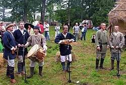 Latvian men's folk ensemble Vilki [lv], performing at the festival of Baltic crafts and warfare Apuolė 854 [lt] in Apuolė Hillfort in August 2009