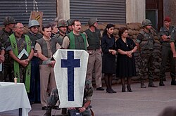 Chaplains, U.S. Marines, and family members observe a moment of silence during a memorial service