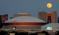 The full moon rises over the Superdome and the city of New Orleans, Louisiana on January 13, 2025.