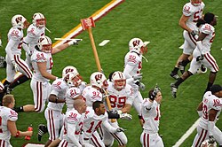 Badgers celebrate their win by carrying Paul Bunyan's Axe after the 2009 Minnesota–Wisconsin football game