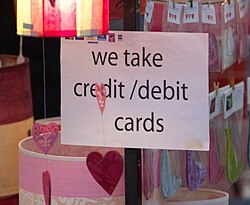 An example of street markets accepting credit cards. Most markets simply display the acceptance marks (stylized logos, as shown in the upper-left corner of the sign) of all cards that they accept.
