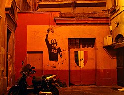 Decal of Totti alongside the Scudetto shield, displayed on a house in Rome