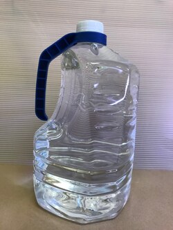 A one-gallon PETE water bottle with attached package handle