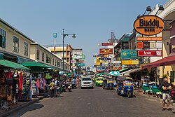 Khao San Road is lined by budget accommodation, shops, and bars catering to tourists.