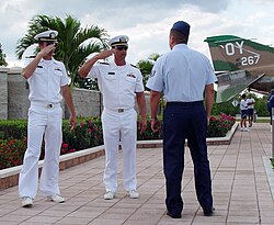 Staff Sergeant Leo Castellano teaches two actors how to salute.