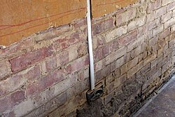Plaster removed from a wall as part of a rising damp treatment. The wall was replastered using a sand-cement render.