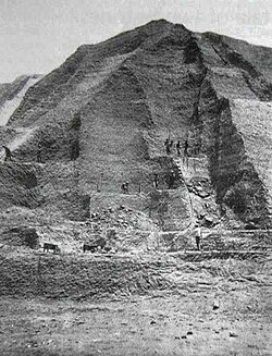 Chinese labourers stand on a partially extracted guano deposit in the Chincha Islands in 1865