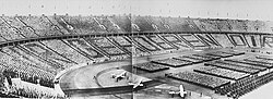 On May Day in 1939, the Führer of Nazi Germany, Adolf Hitler addressed the Hitler youth (HJ) at the Olympic Stadium. The dark jackets of the BdM between the white blouses of the boys of the HJ formed the words WIR GEHÖREN DIR (lit. "WE BELONG (TO) YOU", meaning "We are yours").