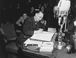 Joseph Smallwood signing the document bringing Newfoundland into the Canadian Confederation