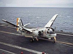 An S-2E Tracker of VS-27 taxies away with wings folding, just after having caught the wire aboard Yorktown during her 1969 Atlantic deployment