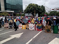 Demonstrators bearing shields at a protest.