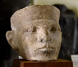 Limestone head of an early Egyptian king, The Petrie Museum. Modern scholars have considered the stone bust to depict an Early Dynastic or Old Kingdom pharaoh.[21][22][23][24]
