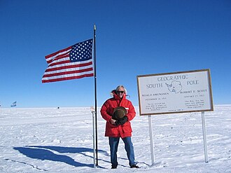 Thiemens at South Pole marker on expedition to dig snow pit for isotope record