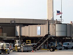 An American flag flies over the airport's departure gate A17 (old Terminal A), where al-Qaeda terrorists boarded United Airlines Flight 93 during the September 11 attacks. Although the gate had been demolished as of 2022, the jetway for Gate A17 was preserved. (pictured in 2006)