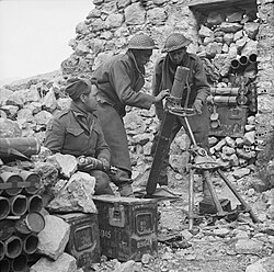 Men of the 6th Battalion, Queen's Own Royal West Kent Regiment man a 3-inch mortar on Monastery Hill, Monte Cassino, Italy, 26 March 1944.
