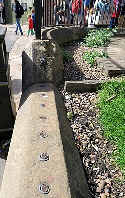 Remnants of iron fence bars in York Whip-Ma-Whop-Ma-Gate. Such public property fences were sawed for the iron and recycled during World War II.