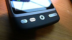 Front buttons (home, menu/options, go back, search) and optical track pad of an HTC Desire, a 2010 smartphone with Android OS
