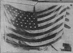 American flag raised by the survivors to show the Allies that they were still alive[6]