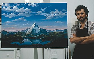 Artist Dario Campanile poses with a picture Paramount commissioned him in 1986 to paint for its 75th anniversary. The company later used the painting as a basis for its new logo. That logo was introduced as a prototype in the 1986 film The Golden Child; the 1987 film Critical Condition are both the first to feature the finalized version of the logo. 1999's South Park: Bigger, Longer & Uncut was the first to use an enhanced version of the logo, which was last used on 2002's Crossroads.