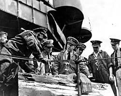 Captain Homer N. Wallin (center) supervises salvage operations aboard USS California in early 1942