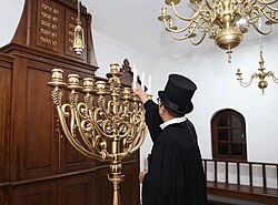 Rabbi Yaakov Baruch (The leader of congregation Shaar Hashamayim) lights the Menorah