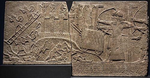 A relief from Tiglath-Pileser's palace in Nimrud, depicting the Assyrians besieging a town
