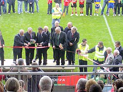 GAA President Nicky Brennan (second from left) cuts the ribbon at the official re-opening of Páirc Esler.