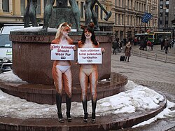 Two young women from PETA, body painted to look like foxes, protesting against the fur trade next to the Three Smiths Statue in Helsinki, Finland on March 25, 2010