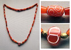 The etched carnelian beads in this necklace from the Royal Cemetery of Ur dating to the First Dynasty of Ur (2600-2500 BCE) were probably imported from the Indus Valley.[8]