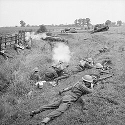 Home Guard troops 'fighting' Valentine tanks of 6th Armoured Division during large-scale manoeuvres, 27 July 1941.
