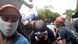 Protesters protecting themselves from rubber bullets.