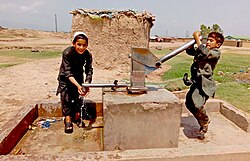 Afghan children near Islamabad fetching water from water pump. (Pakistan once held the second largest refugee population globally after Turkey.[537])
