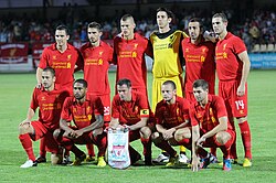 Liverpool F.C. team photo prior to a UEFA Europa League match against FC Gomel. Note the difference in attire of goalkeeper Brad Jones (yellow) with that of the rest of his teammates (red).