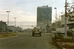 UN troops in front of the Executive Council Building, burned after being struck by tank fire during the siege of Sarajevo, 1995