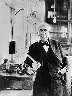 Thomas Alva Edison with a light bulb from 1883.