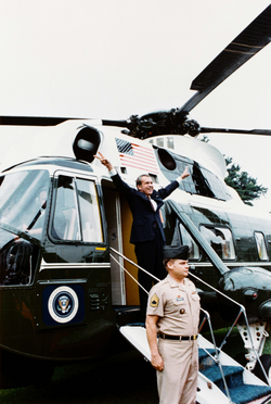 Nixon displays the V-for-victory sign as he departs the White House after resigning the presidency on August 9, 1974