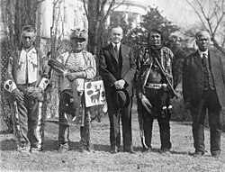 President Coolidge stands with four Osage Indians at a White House ceremony