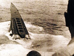 A Type XB submarine sinking in the Atlantic. On the foredeck the vertical mineshafts are visible.