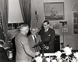 Ben-Gurion (center) giving U.S. President Harry S. Truman (left) a Menorah as a gift. To the right is Abba Eban, the Ambassador of Israel to the U.S.