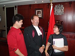 A Canadian citizenship judge in court dress during a citizenship ceremony