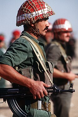 Syrian honor guard stands at attention during Operation Desert Shield. The soldier is armed with an AK-47 assault rifle.