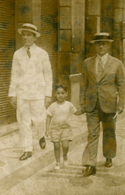 Cardoso walking hand-in-hand with his father in the 1930s