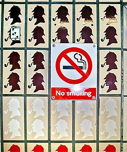 An ironic message: a "no smoking" sign has been placed over a pattern depicting a man smoking a tobacco pipe.