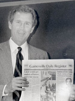 Texas Gov. George W. Bush holds a copy of the Gainesville Daily Register during a visit to Gainesville, Texas, circa 1998.