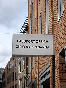 Bilingual sign in Ireland. The eclipsis of P to bP uses lower case in an otherwise all caps text.