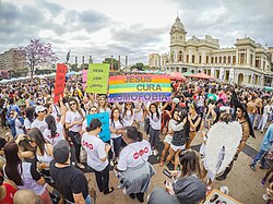Signs reading "God loves everyone" and "Jesus heals homophobia" at the 2015 Belo Horizonte Pride Parade in Brazil.