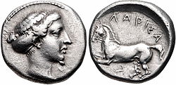 Silver drachma of Larissa (410-405 BC). Head of the nymph Larissa left, wearing pearl earring, her hair bound in sakkos / ΛΑΡΙΣΑ above, [IA] below (retrograde), bridled horse -symbol of the city- galloping right.
