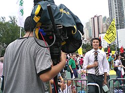 TV news reporter in Hong Kong (2007).