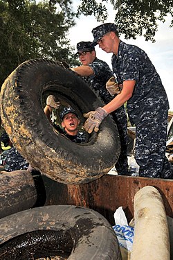 Navy sailors remove and dispose of used tires littering the waterways of a naval base in Charleston, South Carolina.