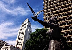 The "Embodied" statue, representing justice, in the Civic Center neighborhood of Los Angeles, California, which mostly consists of City of Los Angeles government offices. Visible in the background are the Los Angeles City Hall and the Clara Shortridge Foltz Criminal Justice Center.